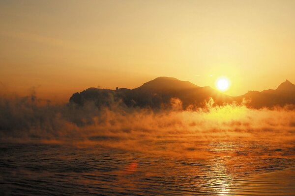 The sun rises over the mountains. landscape