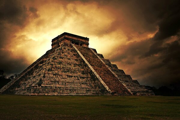 The Mayan pyramid on the background of a dramatic dark yellow sky