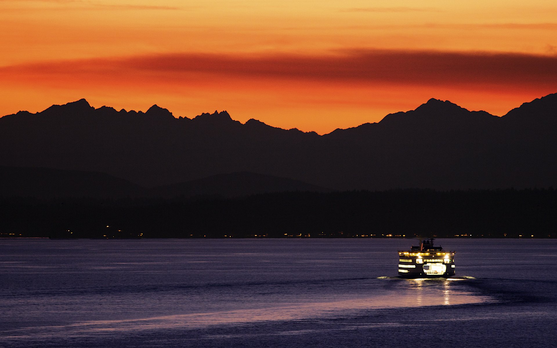 ferry lamps mountain orange sea sky sunset water