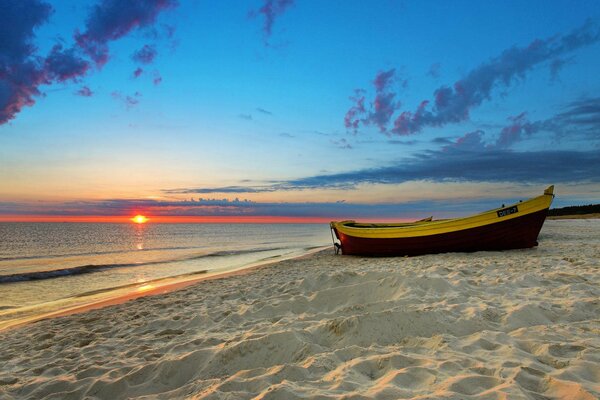 A boat on an empty sandy shore