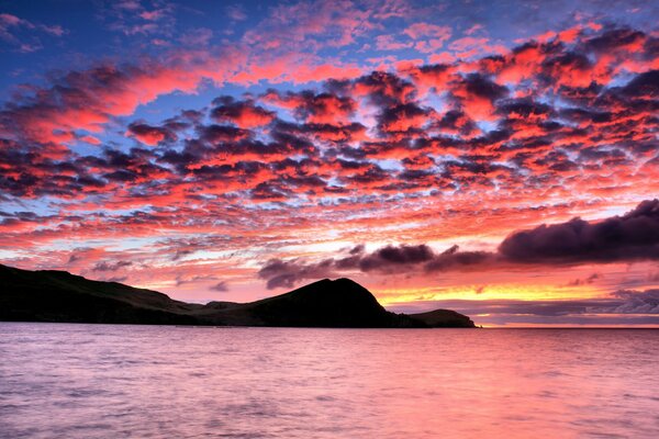 Silhouette of mountains and sea at sunset