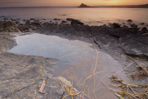 A puddle on the shore among the stones