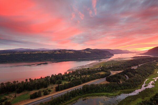 Red sunset over the river and forest