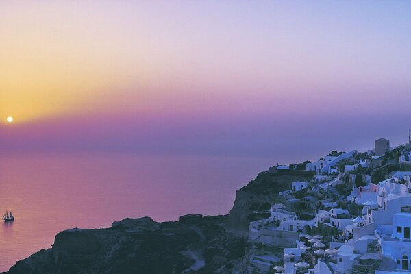 Colorful sunrise over the ocean near a small town