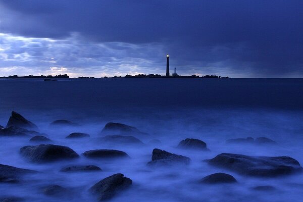 Distant lighthouse in the blue-blue sea