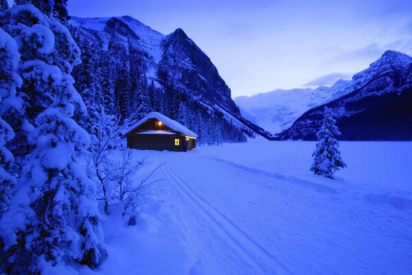 Maison dans la forêt enneigée d hiver