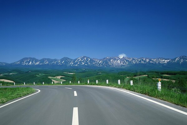 Blue sky. The road leading to the hills on the horizon