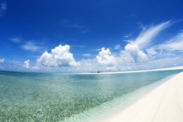 Sandy seashore and sky with clouds