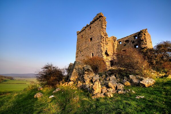 Ruins against the background of grass and clouds