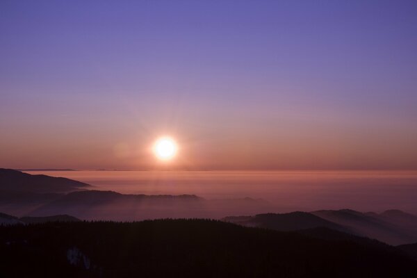 Sunset in the fog, the sun on the horizon