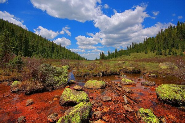 A swamp in rocks against a background of clouds