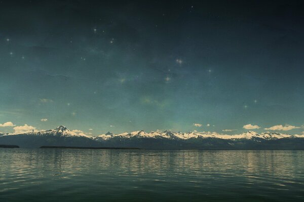 Lake on the background of mountains and sky