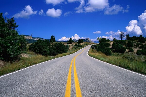 Die Straße im Feld und der helle Himmel