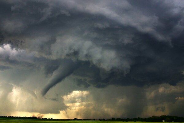 There is a terrible storm and tornado over the field