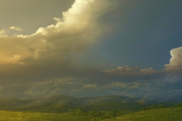 The hills are green against the clouds