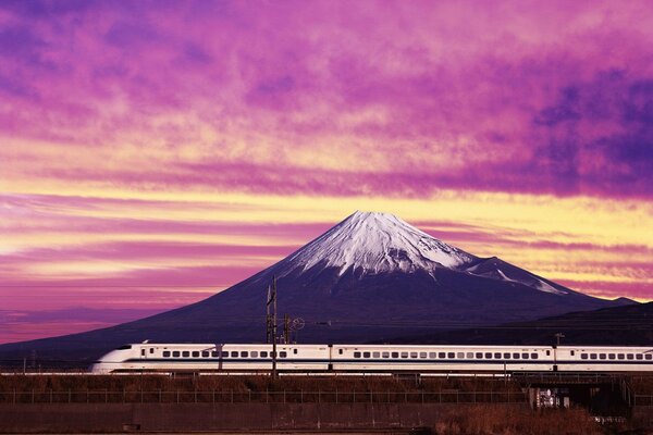 A train in Japan on the background of a snow-covered mountain