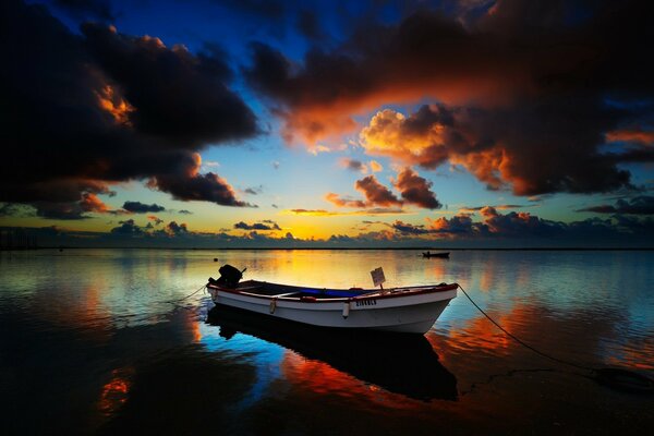 Boat on the background of sunset. evening on the river