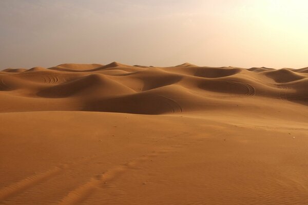 Desert dunes and hills with footprints in the sand