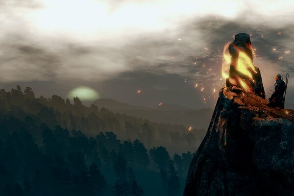 The Witcher on the mountain is burning a bonfire