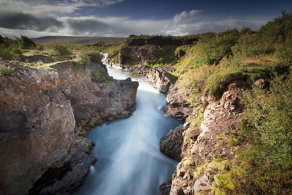 A river among rocks and clouds