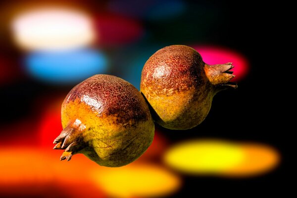 Macro photography of two ripe pomegranates