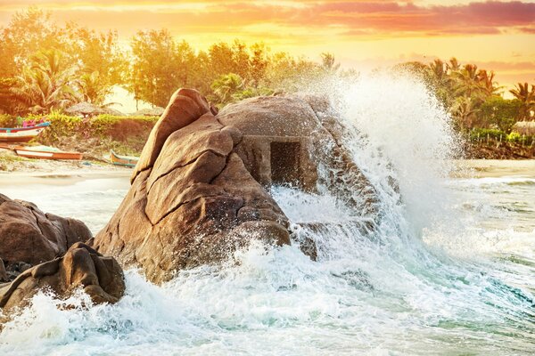 In ancient India, the ruins of an ancient temple stand on the beach on the ocean in the water, and a temple stands like a rock in a cave