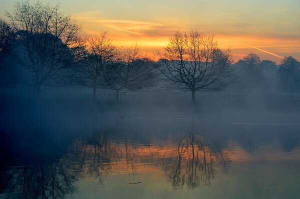 Beautiful sunset on a misty lake