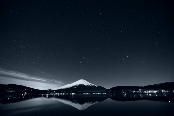 Reflection of mountains on the water. Black and white photo