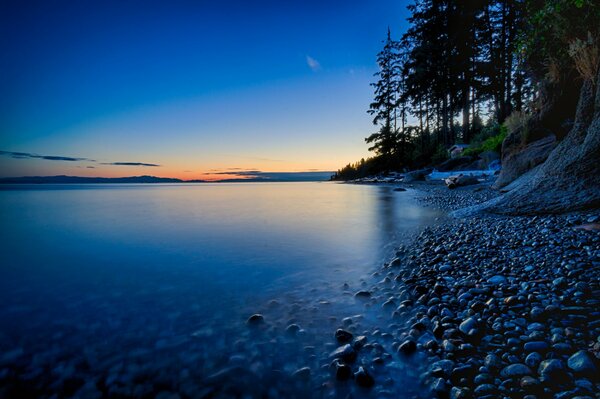 Beautiful sunset on the shore by the lake