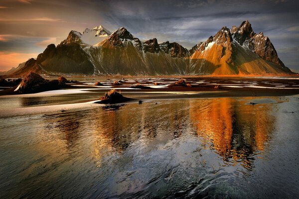 Water against the background of mountains and sunset sky