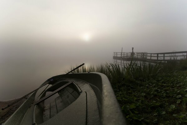 Mañana con niebla y barco en el lago