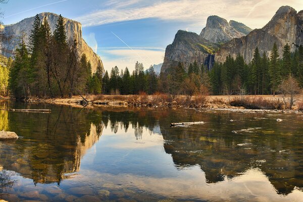 Mirror image of mountains in crystal clear water