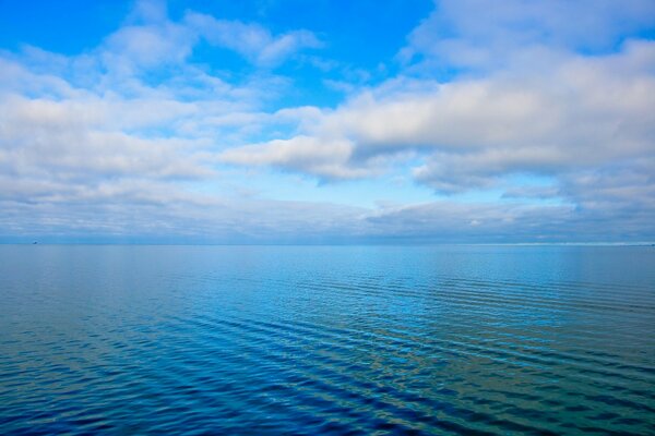 Nuvole sopra il mare blu nella calma