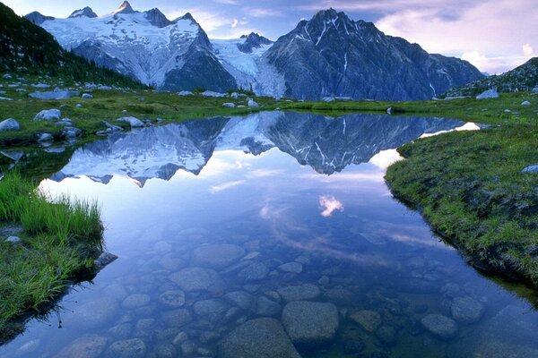 A calm transparent river among mountain ranges