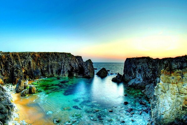 Gorgeous sunset on the beach with rocks