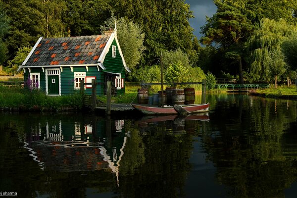 Green boat house by the lake