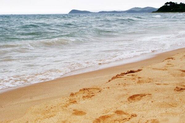 Blue sea waves on the sand