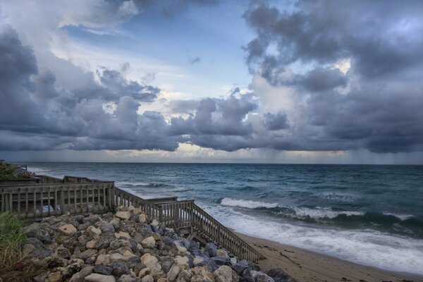 A staircase on the rocks leading to the choppy sea