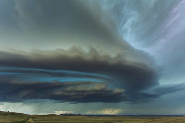 A large thundercloud over the field