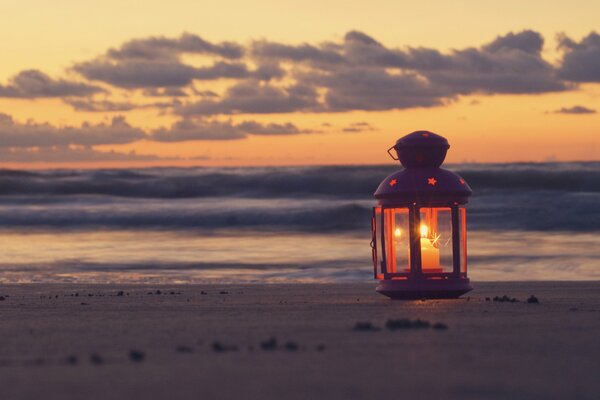 Candle on the seashore. Beautiful sunset