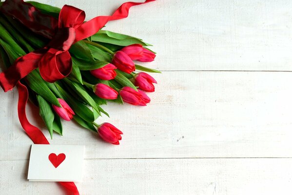 A gift for a loved one: elegant tulips and a postcard