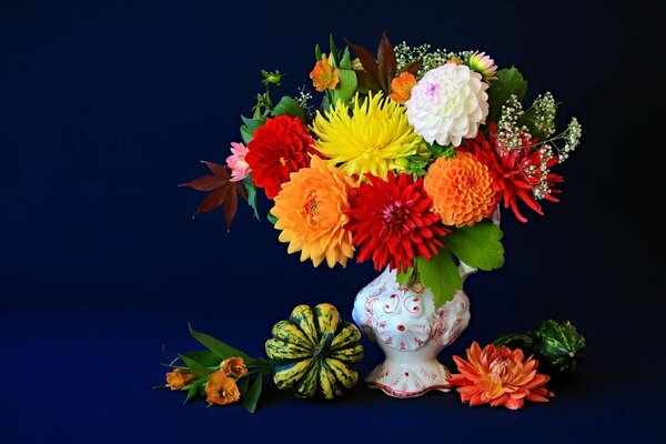 Blumen in einer Vase auf blauem Hintergrund. Stillleben