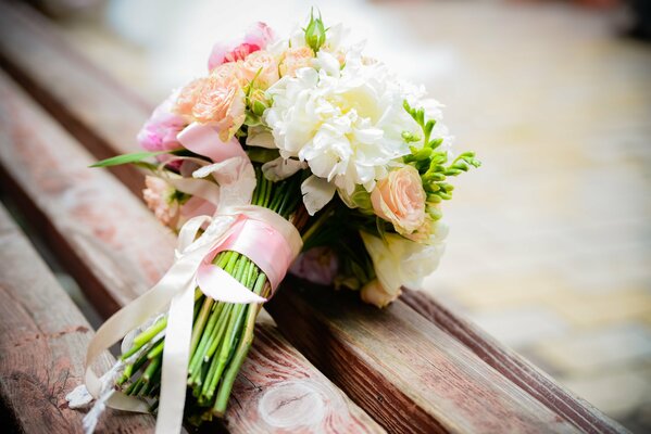 Bouquet da sposa di peonie su una panchina