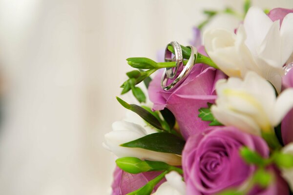 Engagement rings on a bouquet of colorful flowers