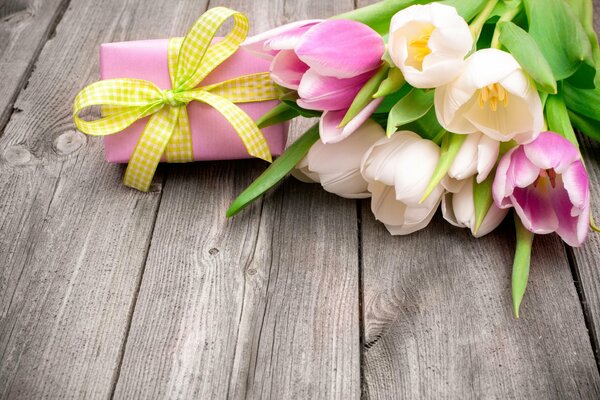 Bouquet of tulips with a gift