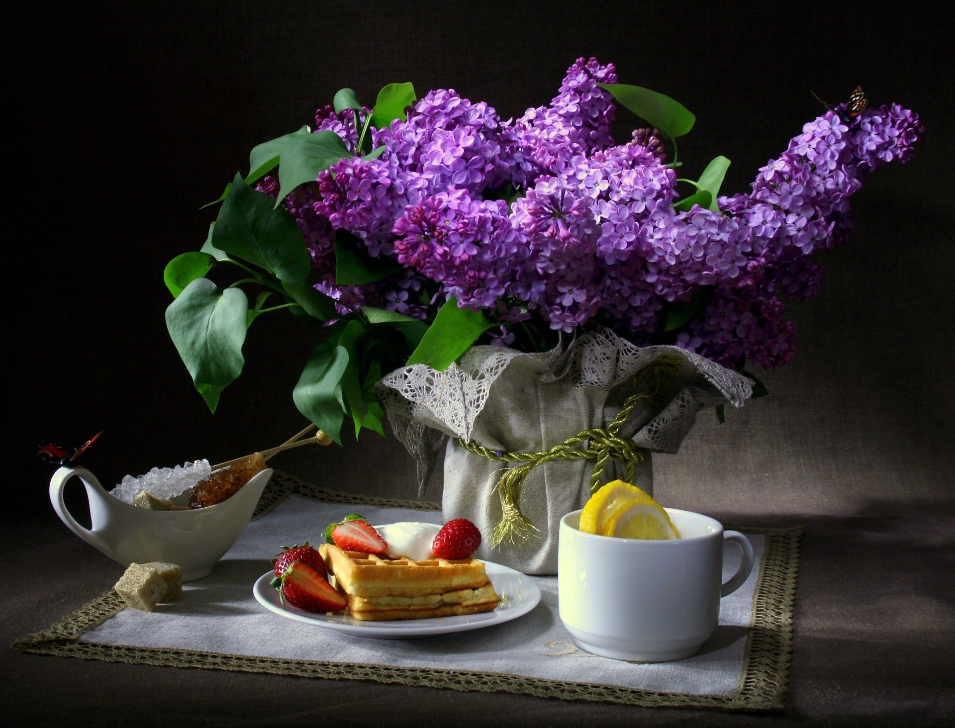 till life flower lilac butterfly breakfast wafer strawberry cup lemon sugar napkin dark background