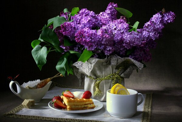 Still life breakfast and lilac in a vase