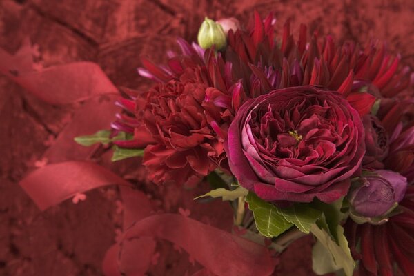 Burgundy flowers with a red ribbon