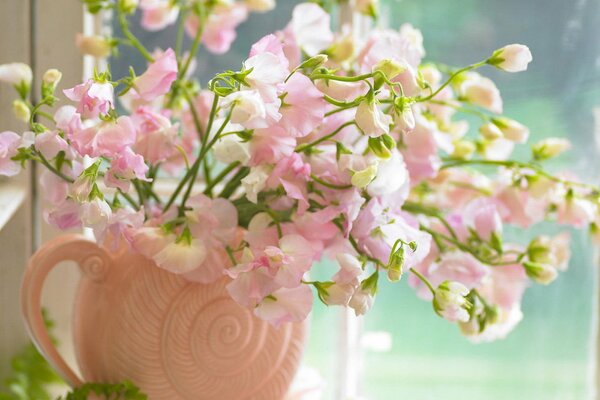 Pink bouquet in a vase by the window