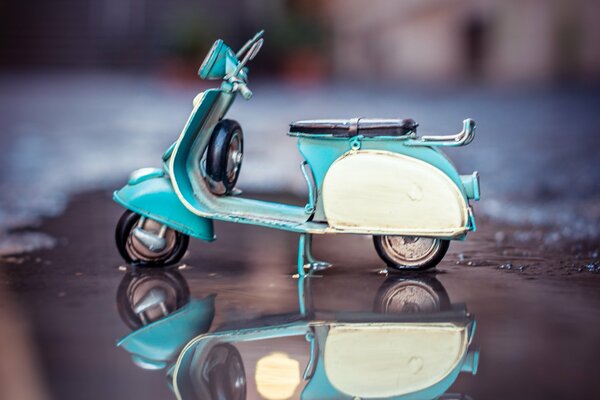 A model of a scooter in a stream on asphalt